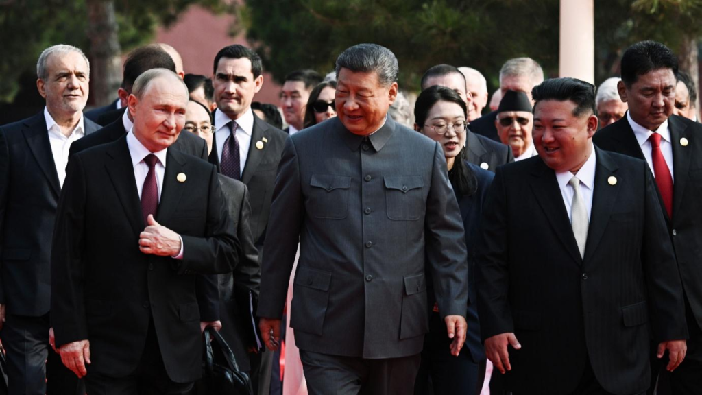 Russian President Vladimir Putin, Chinese President Xi Jinping and North Korean leader Kim Jong Un walk side by side